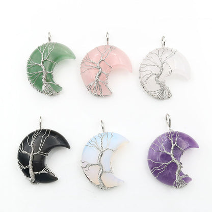 A collection of Tree of Life crescent moon crystal pendants in various colors, each featuring a crescent shape with a tree design in the center.